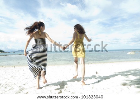 woman hang out  together sand by sea edge on blue sky background