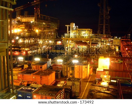 North sea gas rig night dark lights  waves industry  harsh environment platform legs steel energy