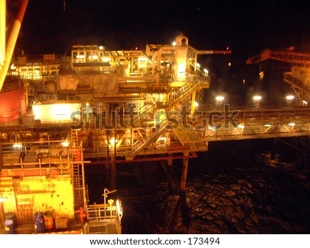 North sea gas rig night dark lights  waves industry  harsh environment platform legs steel energy
