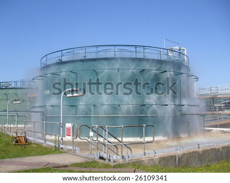 Industrial tanks with water spray fire extinguisher and cooling system.