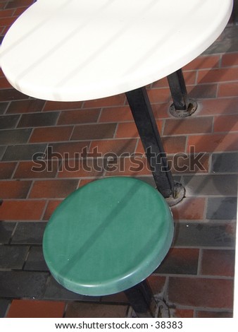 One table and seat with tiled floor outside