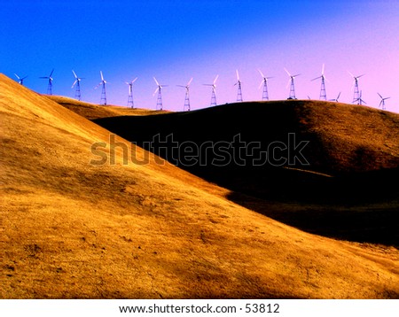 sunset over golden hills with wind mills