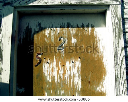 old door with flaky paint and numbers