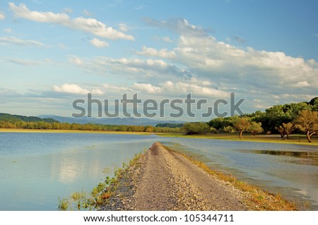 Road going under water in a lake