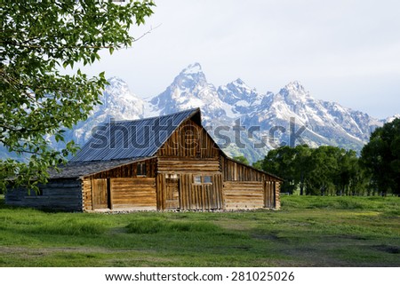 Famous historic barn beneath snow capped mountains in the Grand Tetons.