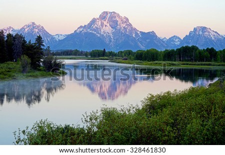 Dawn colors on snow capped mountains in the Grand Tetons.