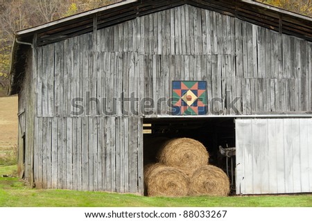 Country barn filled with hay decorated with a quilt pattern