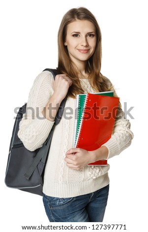 Young woman wearing a backpack and holding notebooks ready to go to class, over white background