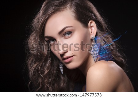 Closeup of luxury woman wearing diamond earrings