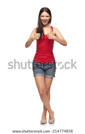 Full length of young cute smiling emotional girl giving you thumb up, isolated on white