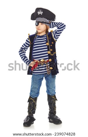 Full length little boy wearing pirate costume posing with hand on hat, looking away, over white background