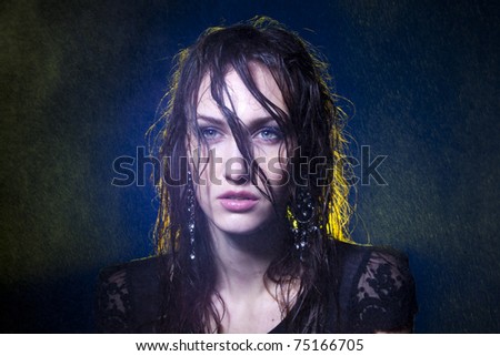 Fine art portrait of wet hair female under spots of rain. Shallow depth-of-field.