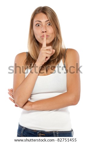 stock photo Young emotional woman with finger on lips isolated on white