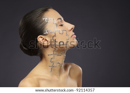 Side view portrait of female with beauty crystal puzzle on her face