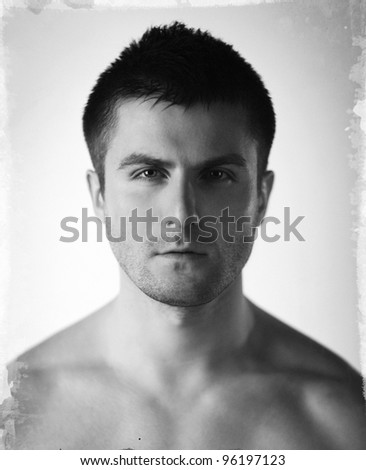 Vintage stylized fine art close-up black and white portrait of beautiful young man, shallow deep of field