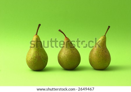 Three pears on green background