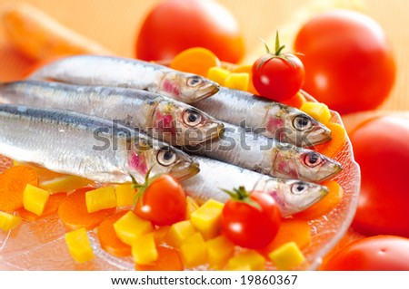 Group of sardines on different vegetables