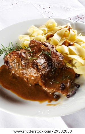 Rabbit steak with pasta noodles , rosemary and spicy sauce