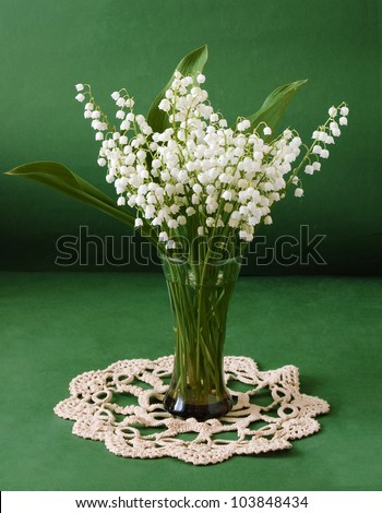 Still life with lily of the valley flowers bunch on artistic background