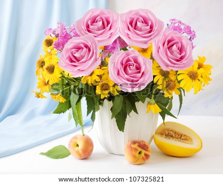 Still life with huge bunch of summer flowers and roses, melon and peaches