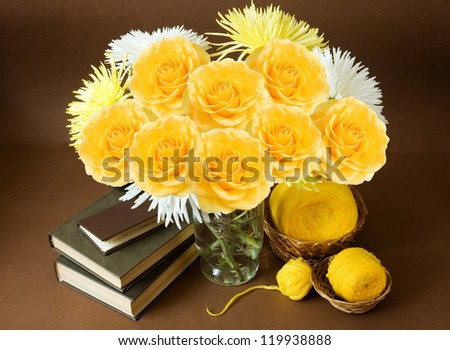 Still life with roses bunch, book and hank of wool on artistic background.Teacher Day