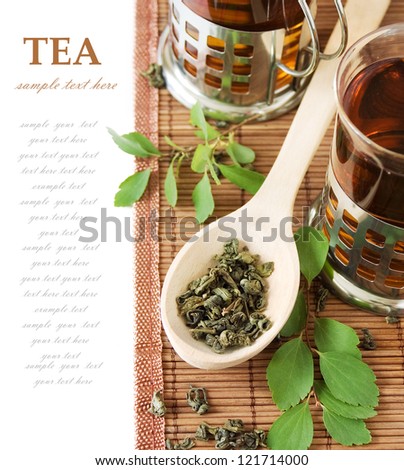 Asian Tea (still life with tea, cup of tea,green leaves and bamboo mat isolated on white background with sample text)