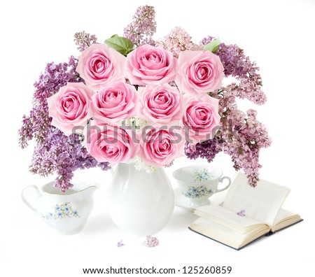 Mother Day (still life with huge bunch of roses and lilac flowers, book, cup and milk jug isolated on white background)
