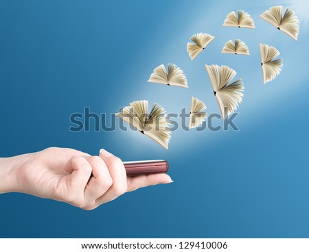 Hand holding modern mobile phone and books flying away