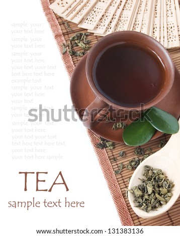 Tea breakfast (still life with asian  tea cup and fresh green leaves isolated on white background with sample text)
