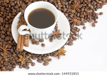 Cup of coffee with spice and coffee beans isolated on white background