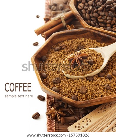 Wooden bowls with coffee beans and ground coffee, spice and spoon isolated on white (with sample text)