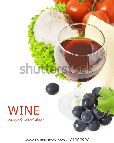 Grapes and cheese with   glass of red wine, meat, lettuce and tomatoes isolated on white background