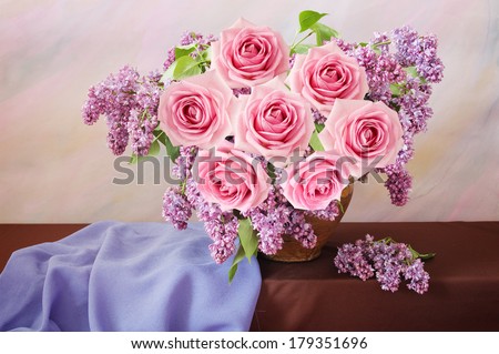 Still life with huge bunch of roses, lilac flowers on painting background