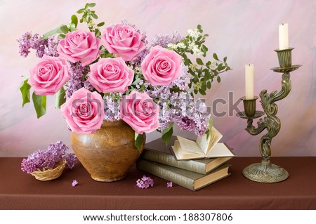 Still life with lilac and roses bunch and books on artistic background. Teacher\'s day