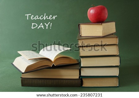 World Teacher\'s Day (still life with book pile, apple and desk on artistic background)