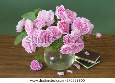 Still life with roses bunch and book pile on artistic background. World Teacher\'s Day