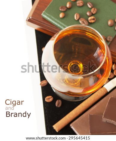 Brandy and cigar isolated on white background with sample text