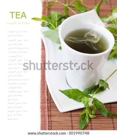 Tea breakfast (still life with tea cup and fresh green leaves isolated on white background with sample text)