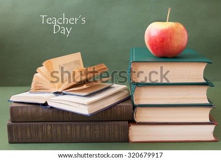 World Teacher\'s Day (still life with book pile, apple, globe and desk on artistic background)