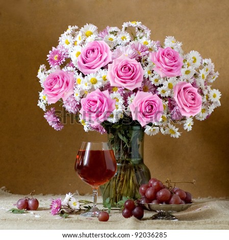 Still life with huge bunch of autumn flowers and roses, fruits and wine