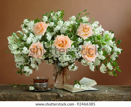 Teacher day (huge bunch of white spring flowers and roses,open book and cup of black tea)