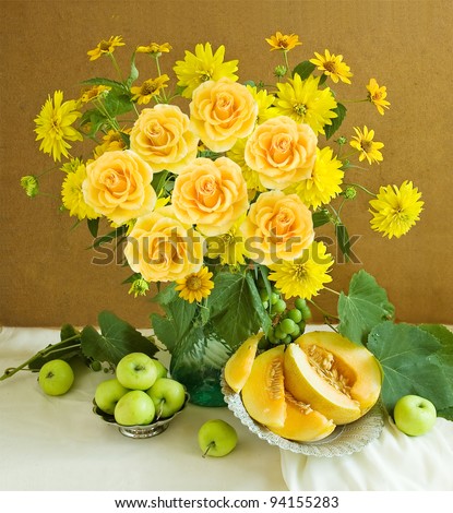 Artistic still life with huge bunch of roses and summer flowers and fruits(melon and green apples)