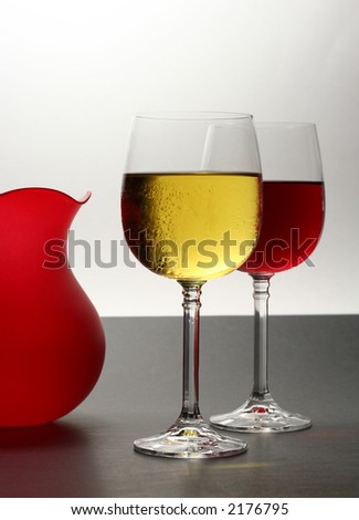 white and red wine with red vase on bi-colored background