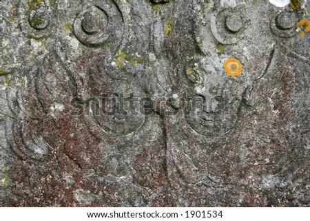 Angel faces on an old gravestone