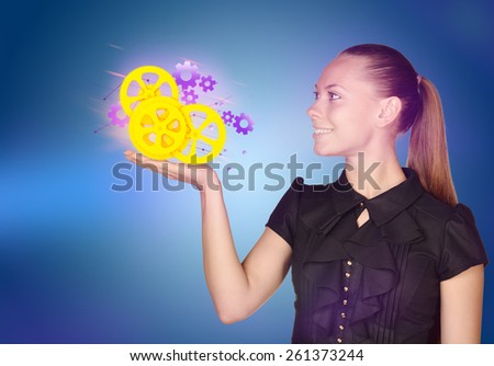 Business woman holding a colorful gears of the clock.