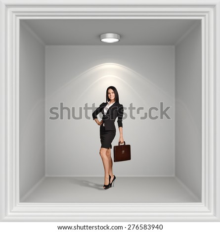 Young girl with leather briefcase standing in window lights on top.