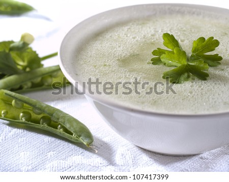 Cream vegetarian vegetable soup with pea pods.