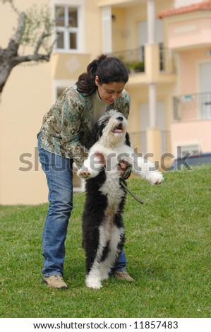 Happy woman with her dog (baby Old English Sheepdog)