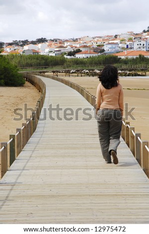 women walking on a wood bridge