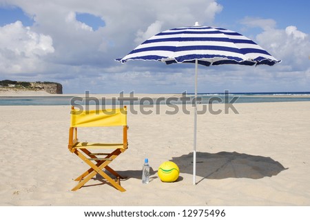 chair, water bottle, ball on the beach